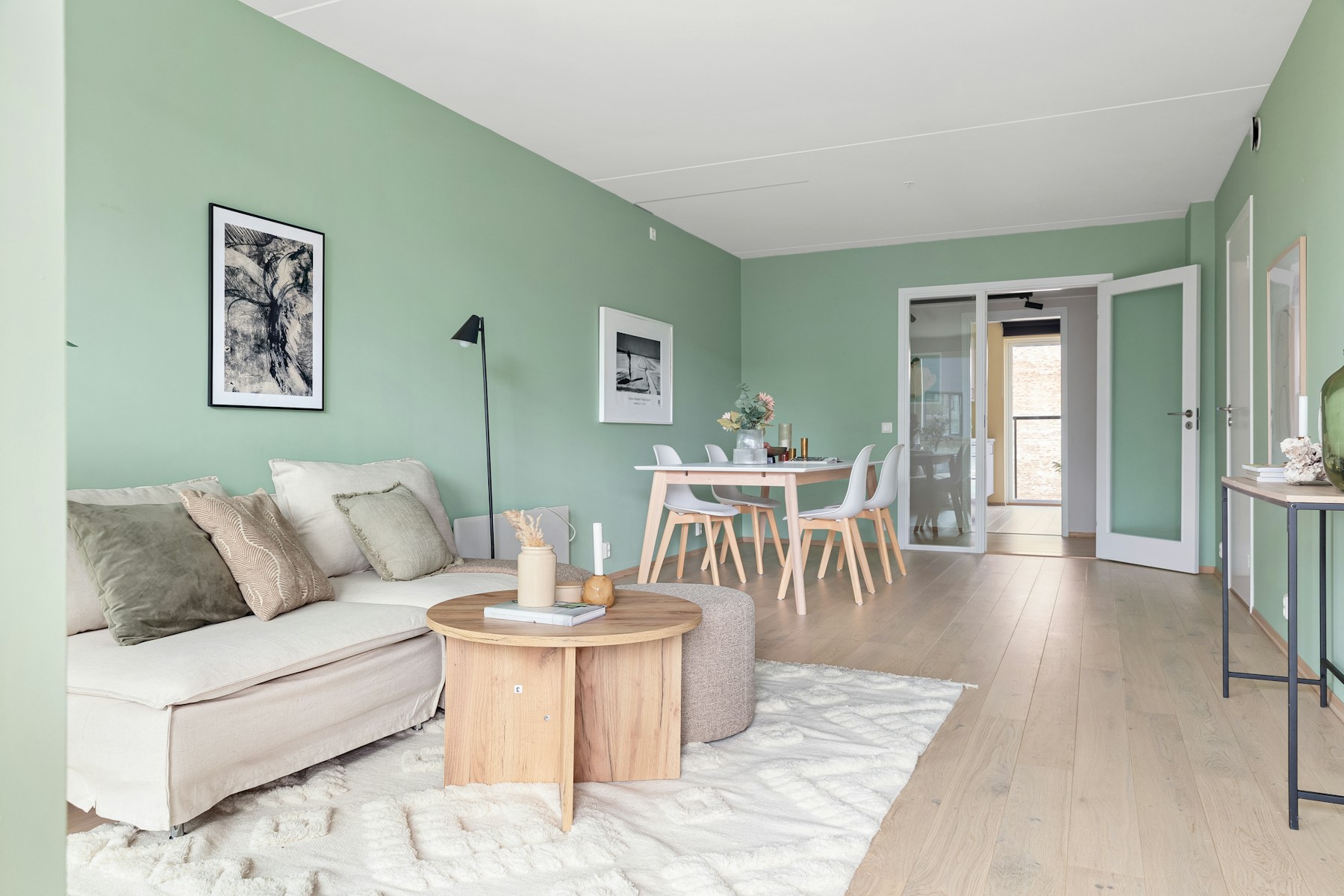 Light-filled living room with sage walls and white trim